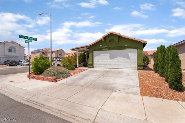 view of front of property featuring driveway, a residential view, and stucco siding