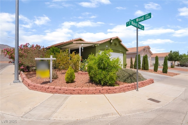 view of property featuring concrete driveway and a garage