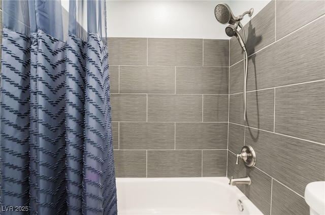 bathroom with shower / bath combo with shower curtain and toilet