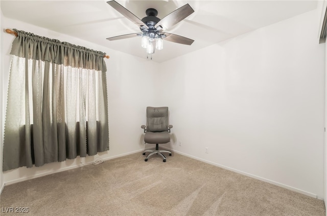 carpeted spare room featuring baseboards and ceiling fan