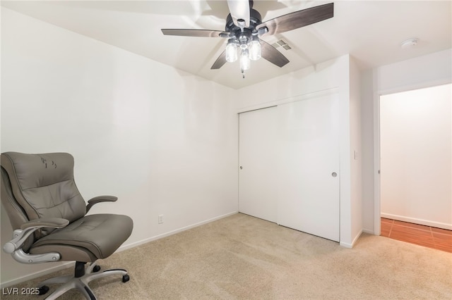 unfurnished room featuring light carpet, ceiling fan, and baseboards
