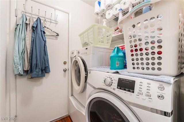 laundry area with independent washer and dryer and wood finished floors