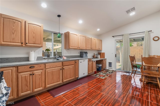 kitchen with dishwasher, a sink, lofted ceiling, decorative light fixtures, and light brown cabinets