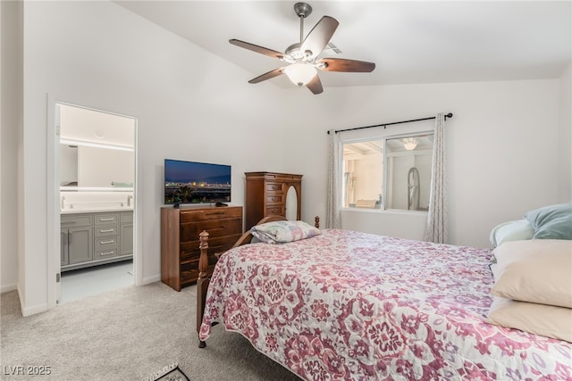 carpeted bedroom featuring lofted ceiling, ceiling fan, and ensuite bath
