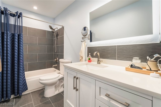 bathroom featuring toilet, shower / bath combination with curtain, and vanity