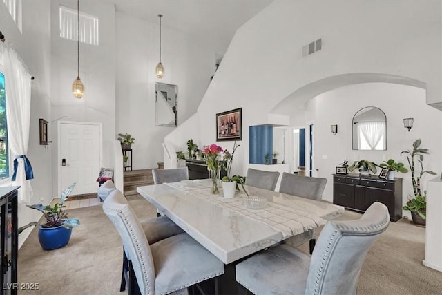3389 Commendation Dr, Las Vegas, NV 89117 - dining area featuring high vaulted ceiling, light carpet, and arched walkways