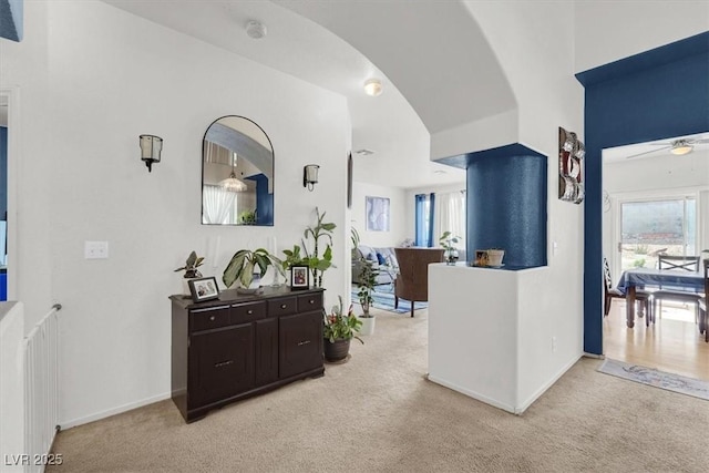 3389 Commendation Dr, Las Vegas, NV 89117 - hallway featuring light colored carpet, healthy amount of natural light, and baseboards