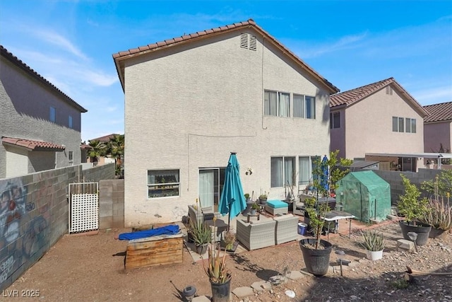 3389 Commendation Dr, Las Vegas, NV 89117 - rear view of property featuring an outdoor living space, stucco siding, a fenced backyard, and a patio