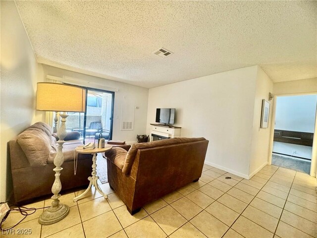 3151 Soaring Gulls Dr Unit 1023, Las Vegas, NV 89128 - living room featuring light tile patterned floors, a textured ceiling, and baseboards