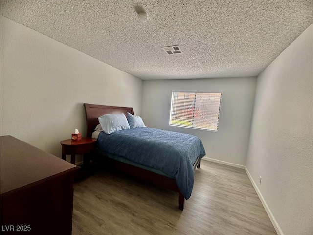 3151 Soaring Gulls Dr Unit 1023, Las Vegas, NV 89128 - bedroom with wood finished floors, a textured ceiling, and baseboards