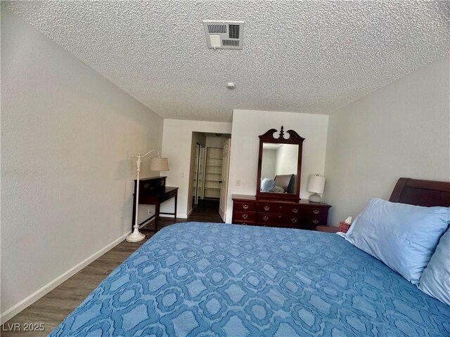 3151 Soaring Gulls Dr Unit 1023, Las Vegas, NV 89128 - bedroom featuring wood finished floors, a textured ceiling, and baseboards