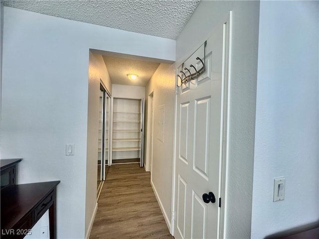 3151 Soaring Gulls Dr Unit 1023, Las Vegas, NV 89128 - hall featuring a textured ceiling, baseboards, and wood finished floors