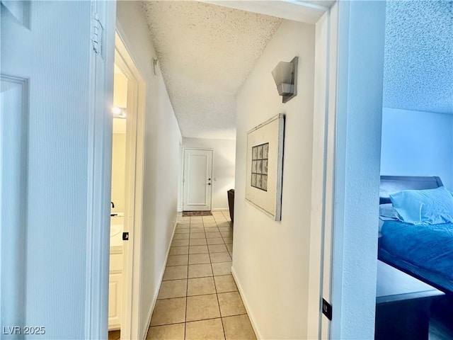 3151 Soaring Gulls Dr Unit 1023, Las Vegas, NV 89128 - hall featuring a textured ceiling, light tile patterned floors, and baseboards