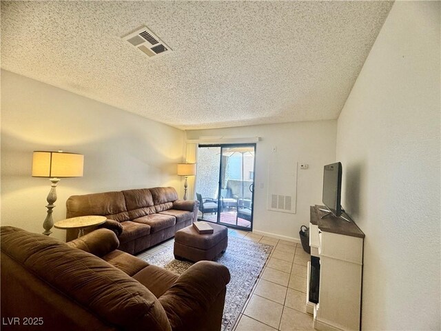 3151 Soaring Gulls Dr Unit 1023, Las Vegas, NV 89128 - living area with light tile patterned floors, a textured ceiling, and baseboards