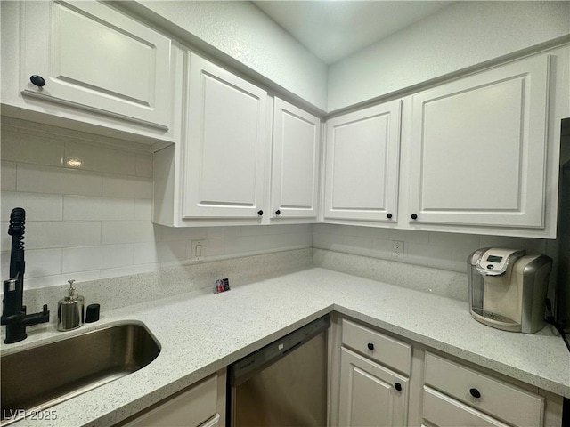 3151 Soaring Gulls Dr Unit 1023, Las Vegas, NV 89128 - kitchen with stainless steel dishwasher, white cabinetry, a sink, backsplash, and light stone counters