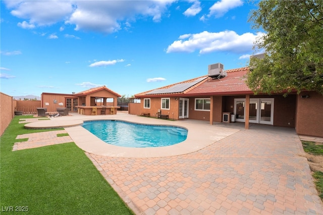 120 N Phyllis St, Las Vegas, NV 89110 - view of swimming pool featuring french doors, central air condition unit, a patio, and a fenced backyard