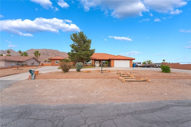 120 N Phyllis St, Las Vegas, NV 89110 - ranch-style house with concrete driveway, a tiled roof, a garage, and a mountain view
