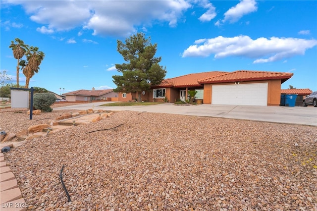 120 N Phyllis St, Las Vegas, NV 89110 - view of front facade featuring a tiled roof, driveway, a garage, and stucco siding