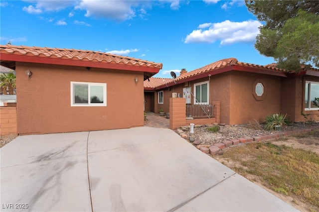 120 N Phyllis St, Las Vegas, NV 89110 - view of front facade with stucco siding, a tiled roof, fence, and a patio