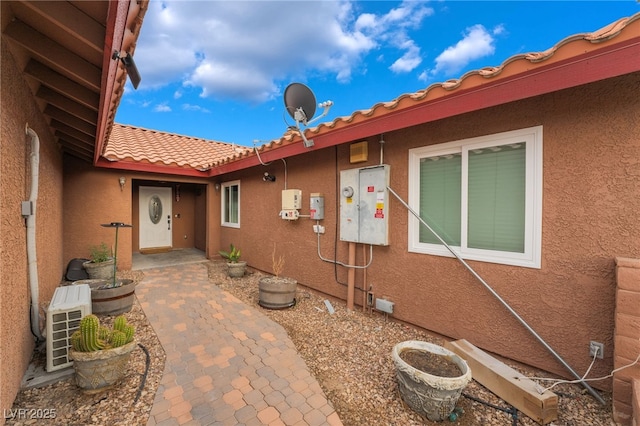 120 N Phyllis St, Las Vegas, NV 89110 - doorway to property featuring stucco siding and a tiled roof