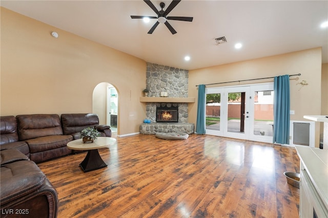 120 N Phyllis St, Las Vegas, NV 89110 - living room with a ceiling fan, wood finished floors, arched walkways, a stone fireplace, and recessed lighting