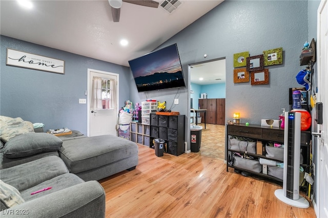 120 N Phyllis St, Las Vegas, NV 89110 - living area featuring a textured wall, wood finished floors, a ceiling fan, and vaulted ceiling