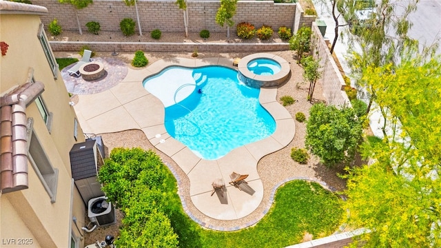 419 Vigo Port St, Las Vegas, NV 89138 - view of swimming pool featuring a patio, a fenced backyard, a pool with connected hot tub, central air condition unit, and an outdoor fire pit