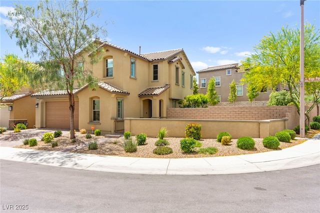 419 Vigo Port St, Las Vegas, NV 89138 - mediterranean / spanish home featuring a fenced front yard, a tile roof, stucco siding, driveway, and an attached garage