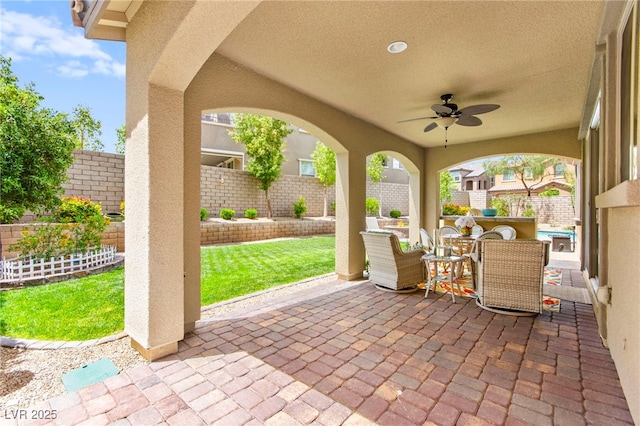 419 Vigo Port St, Las Vegas, NV 89138 - fenced backyard with a patio area, a ceiling fan, and outdoor dining space
