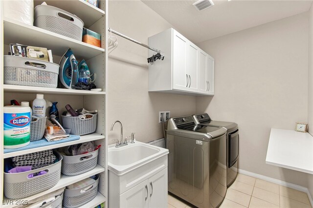 419 Vigo Port St, Las Vegas, NV 89138 - laundry area with cabinet space, washing machine and clothes dryer, light tile patterned flooring, and baseboards