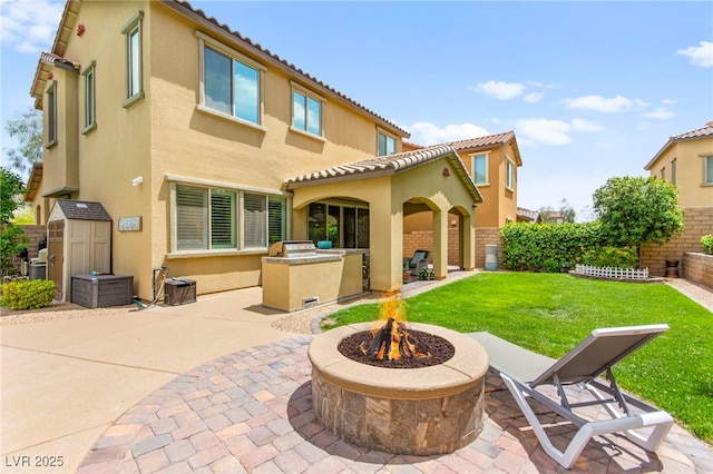 419 Vigo Port St, Las Vegas, NV 89138 - rear view of property featuring an outdoor fire pit, a patio area, and stucco siding