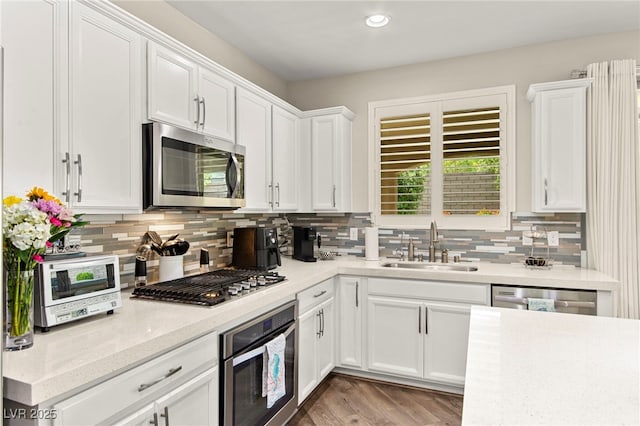 419 Vigo Port St, Las Vegas, NV 89138 - kitchen featuring appliances with stainless steel finishes, a sink, white cabinets, tasteful backsplash, and recessed lighting