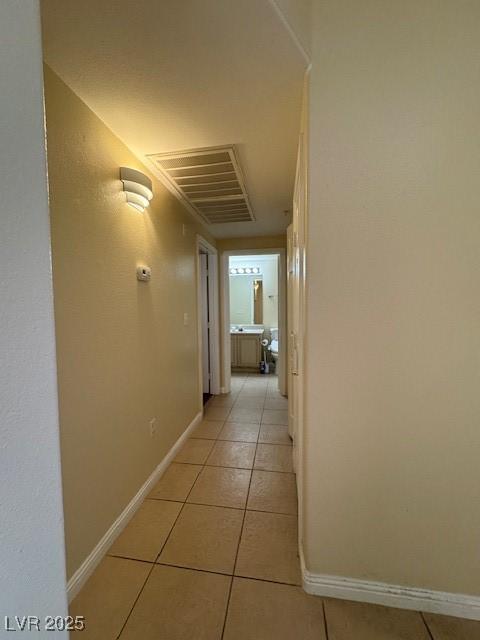 7159 S Durango Dr Unit 206, Las Vegas, NV 89113 - hallway featuring light tile patterned floors and baseboards