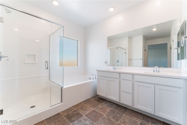 2767 Lindsey Springs St, Las Vegas, NV 89142 - bathroom featuring double vanity, a shower stall, a garden tub, and recessed lighting