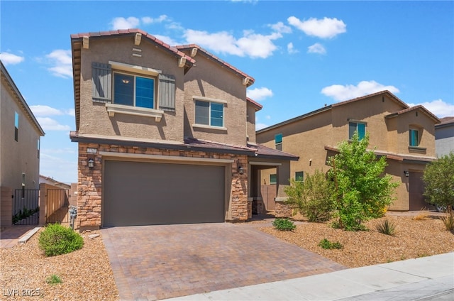 2767 Lindsey Springs St, Las Vegas, NV 89142 - view of front of property with stone siding, a garage, decorative driveway, a gate, and stucco siding