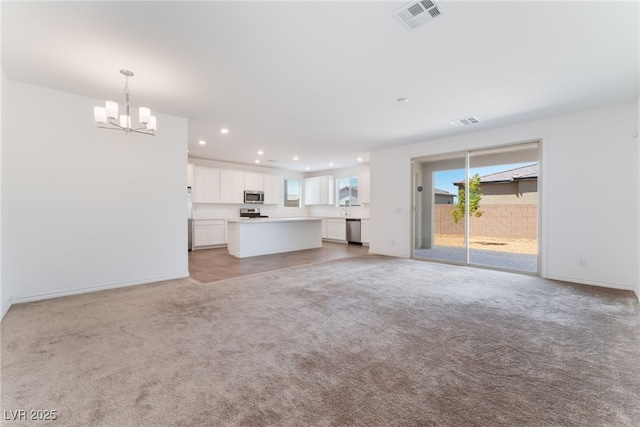 2767 Lindsey Springs St, Las Vegas, NV 89142 - unfurnished living room with a chandelier, recessed lighting, healthy amount of natural light, and light carpet