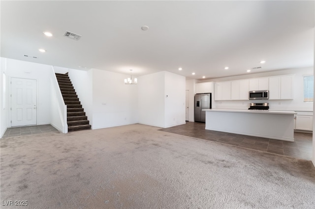 2767 Lindsey Springs St, Las Vegas, NV 89142 - unfurnished living room featuring light colored carpet, a chandelier, stairway, and recessed lighting