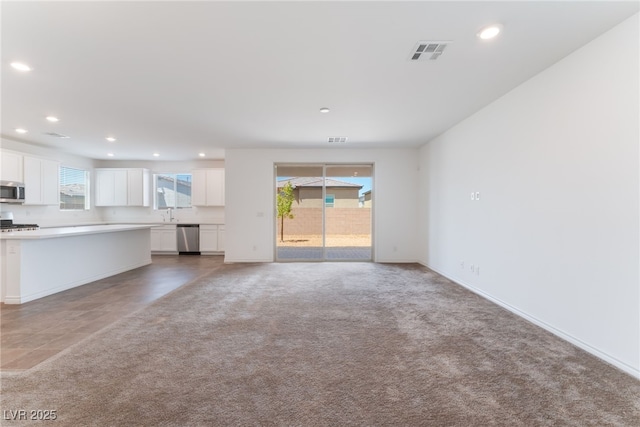 2767 Lindsey Springs St, Las Vegas, NV 89142 - unfurnished living room featuring recessed lighting, plenty of natural light, and light colored carpet