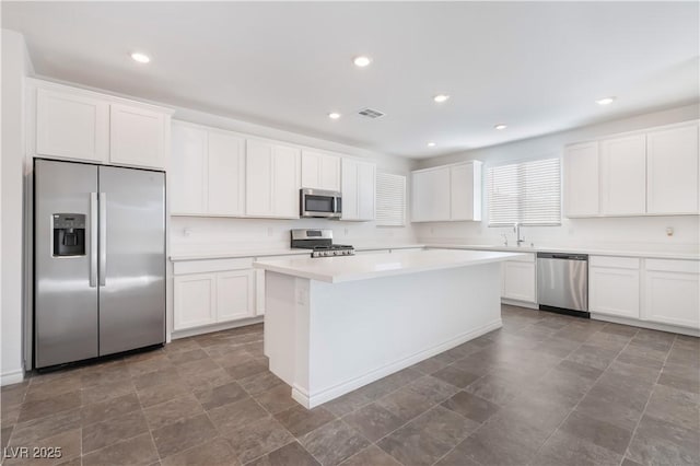 2767 Lindsey Springs St, Las Vegas, NV 89142 - kitchen featuring appliances with stainless steel finishes, white cabinets, light countertops, a center island, and recessed lighting