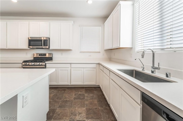 2767 Lindsey Springs St, Las Vegas, NV 89142 - kitchen with appliances with stainless steel finishes, recessed lighting, stone finish flooring, white cabinetry, and light countertops