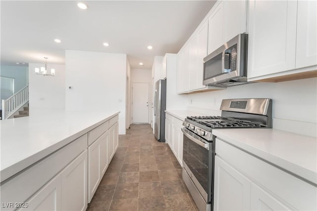 2767 Lindsey Springs St, Las Vegas, NV 89142 - kitchen featuring appliances with stainless steel finishes, light countertops, white cabinets, a chandelier, and recessed lighting
