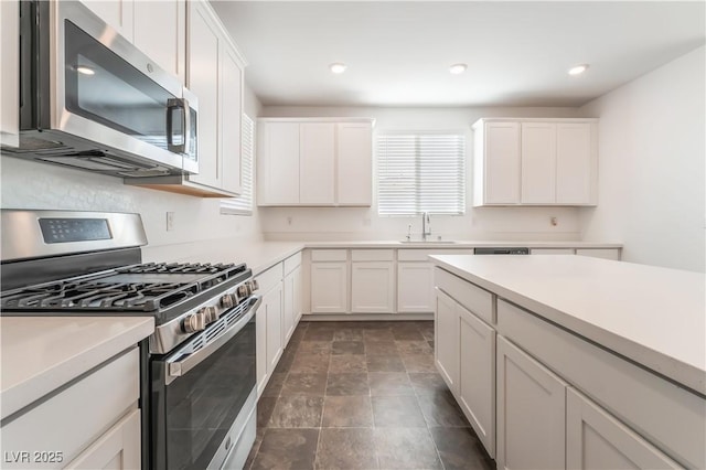 2767 Lindsey Springs St, Las Vegas, NV 89142 - kitchen featuring appliances with stainless steel finishes, light countertops, white cabinetry, recessed lighting, and stone finish floors