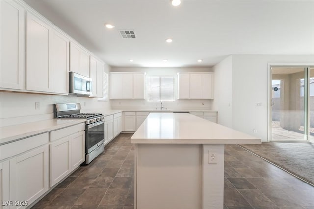 2767 Lindsey Springs St, Las Vegas, NV 89142 - kitchen featuring stainless steel appliances, a kitchen island, light countertops, white cabinetry, and recessed lighting