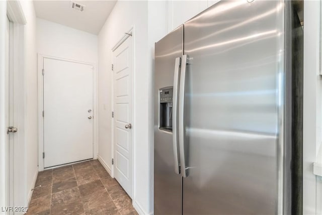 2767 Lindsey Springs St, Las Vegas, NV 89142 - kitchen featuring stainless steel refrigerator with ice dispenser, stone finish floors, and white cabinets