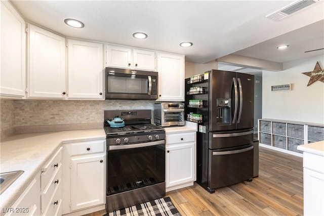 100 Walker Way, Boulder City, NV 89005 - kitchen featuring appliances with stainless steel finishes, white cabinets, light countertops, and recessed lighting