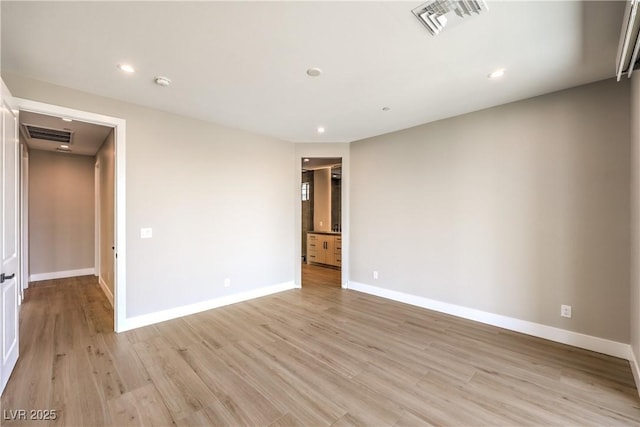 spare room featuring baseboards, light wood-type flooring, recessed lighting, and a smoke detector