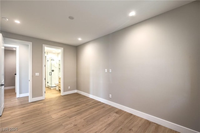 spare room featuring recessed lighting, baseboards, and light wood-type flooring