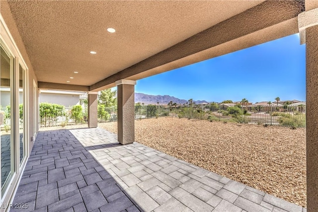 view of patio with a mountain view and a fenced backyard
