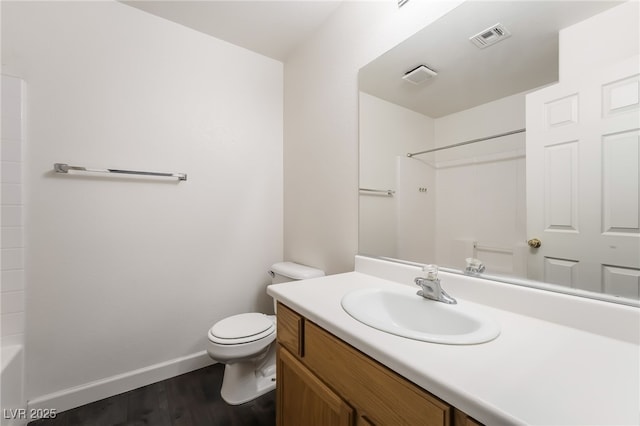 full bathroom featuring toilet, wood finished floors, vanity, and baseboards