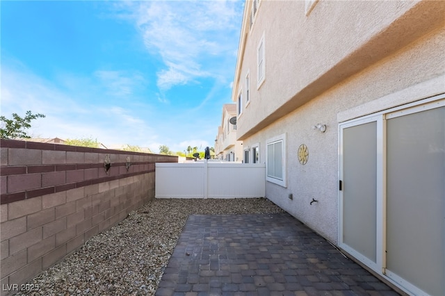 fenced backyard with a patio